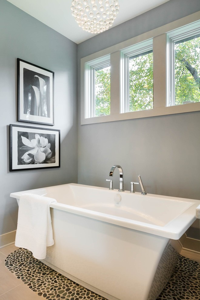 This is an example of a medium sized contemporary ensuite bathroom in Minneapolis with flat-panel cabinets, dark wood cabinets, a freestanding bath, a corner shower, a two-piece toilet, white tiles, ceramic tiles, grey walls, ceramic flooring, a built-in sink and marble worktops.