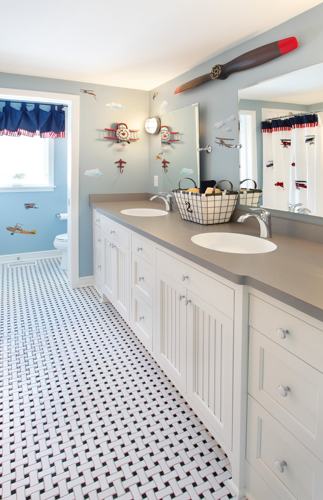Bathroom - kids' bathroom idea in Minneapolis with recessed-panel cabinets, white cabinets, blue walls and gray countertops