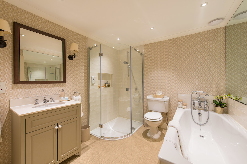 This is an example of a classic ensuite bathroom in Other with raised-panel cabinets, beige cabinets, a corner bath, a corner shower, a two-piece toilet, beige tiles, metro tiles, beige walls, a submerged sink, beige floors, a hinged door and white worktops.