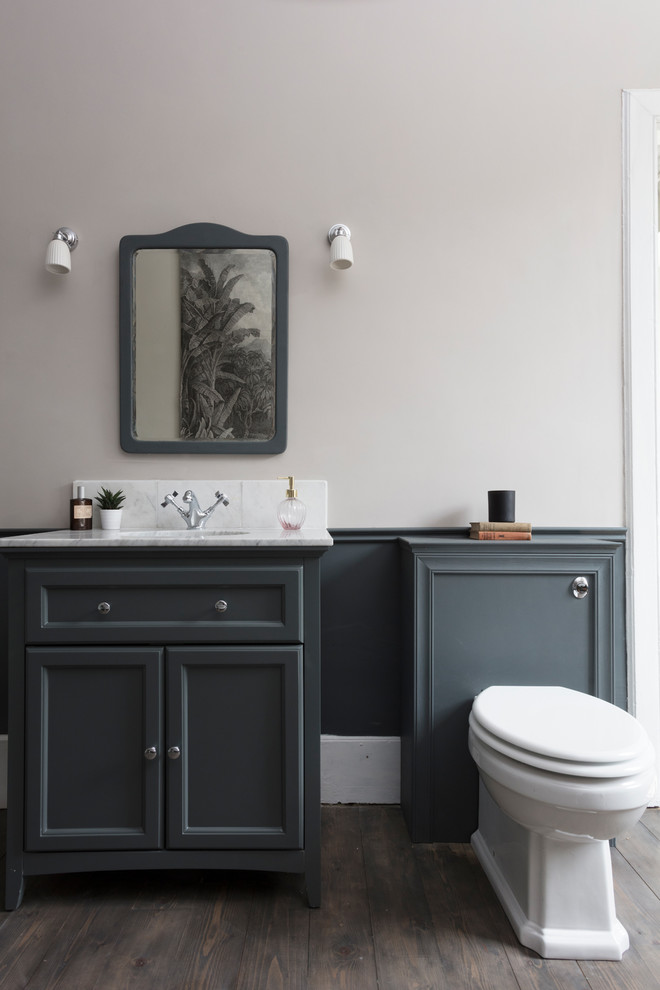 Inspiration for a large classic family bathroom in Edinburgh with freestanding cabinets, grey cabinets, a claw-foot bath, a two-piece toilet, white tiles, marble tiles, grey walls, dark hardwood flooring, a console sink, marble worktops, grey floors, a hinged door and white worktops.