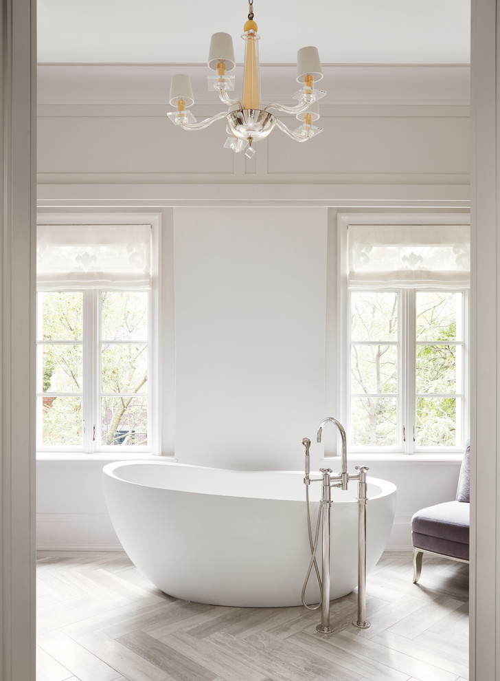 Transitional gray floor freestanding bathtub photo in Chicago with white walls