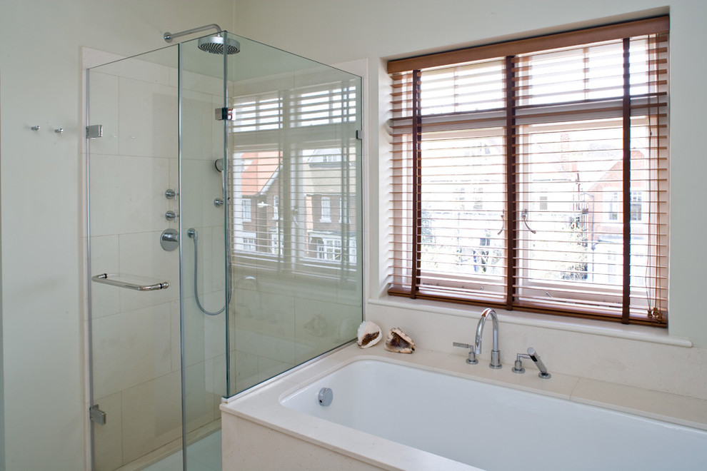 This is an example of a large contemporary ensuite bathroom in Berkshire with marble worktops, marble flooring, a built-in bath and a built-in shower.