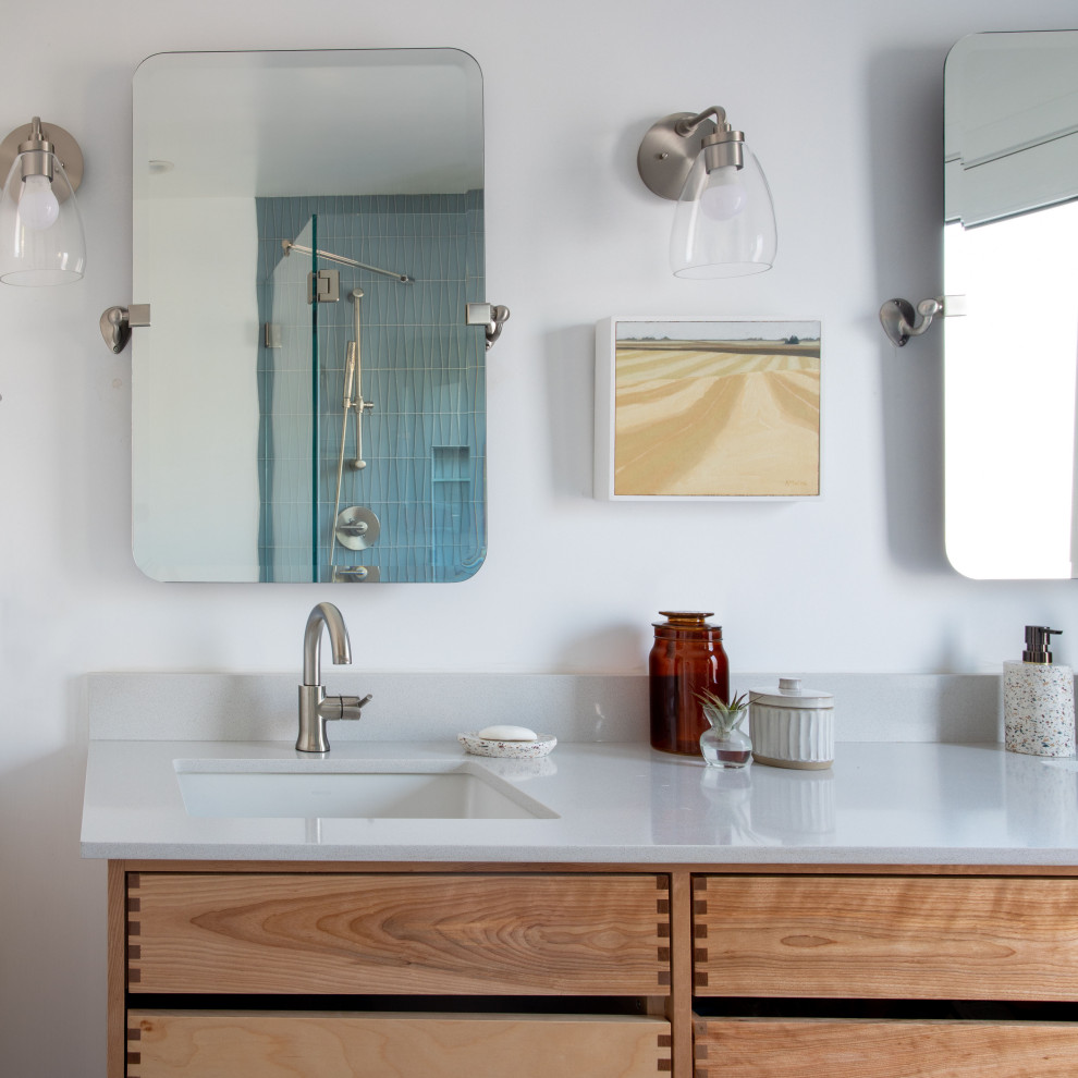 Inspiration for a mid-sized 1960s master white tile and glass tile porcelain tile, gray floor and double-sink double shower remodel in San Francisco with beaded inset cabinets, light wood cabinets, a one-piece toilet, white walls, a drop-in sink, quartz countertops, a hinged shower door, white countertops and a floating vanity