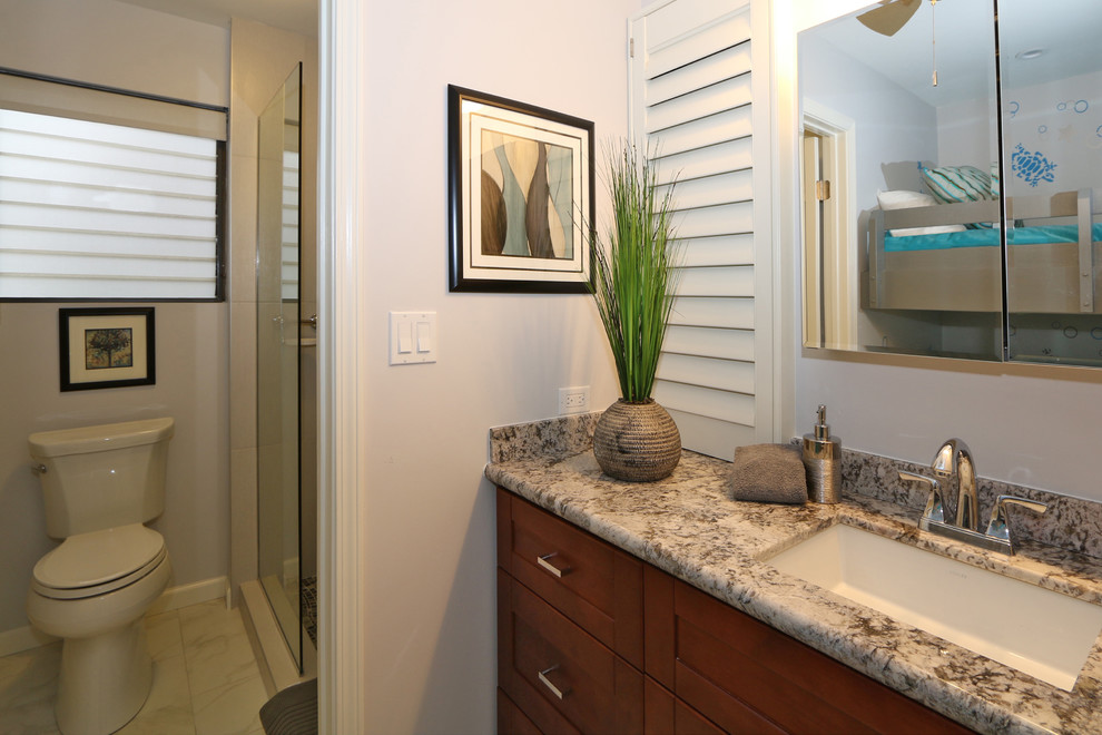 Design ideas for a medium sized world-inspired ensuite bathroom in Hawaii with shaker cabinets, dark wood cabinets, beige tiles, white walls, porcelain flooring, a submerged sink and granite worktops.