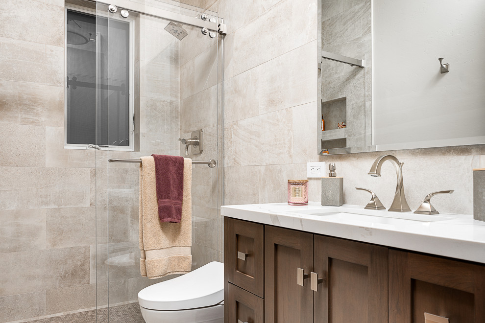 Small elegant 3/4 gray tile and porcelain tile porcelain tile, brown floor and single-sink bathroom photo in San Diego with flat-panel cabinets, black cabinets, a one-piece toilet, gray walls, an undermount sink, marble countertops, gray countertops and a freestanding vanity