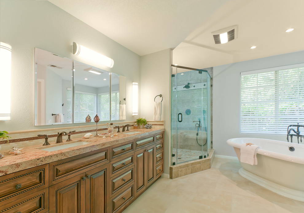Inspiration for a large transitional master multicolored tile and porcelain tile porcelain tile alcove shower remodel in San Diego with an undermount sink, raised-panel cabinets, medium tone wood cabinets, granite countertops, a one-piece toilet and blue walls