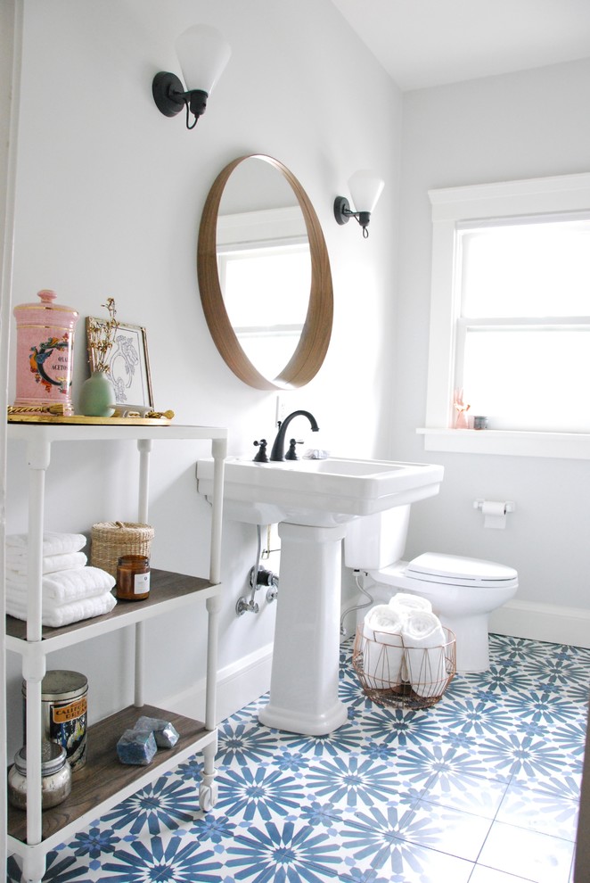 Medium sized eclectic bathroom in San Francisco with a two-piece toilet, blue tiles, cement tiles, grey walls and a pedestal sink.