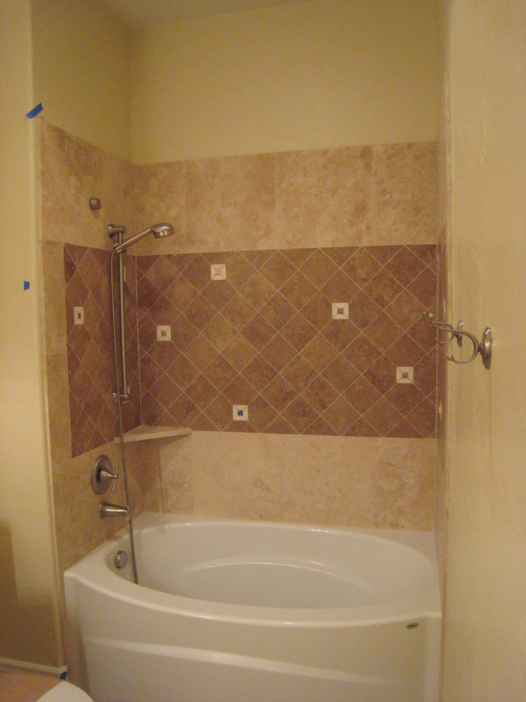 Design ideas for a small mediterranean family bathroom in Boise with a built-in bath, a shower/bath combination, beige tiles, travertine tiles and beige walls.