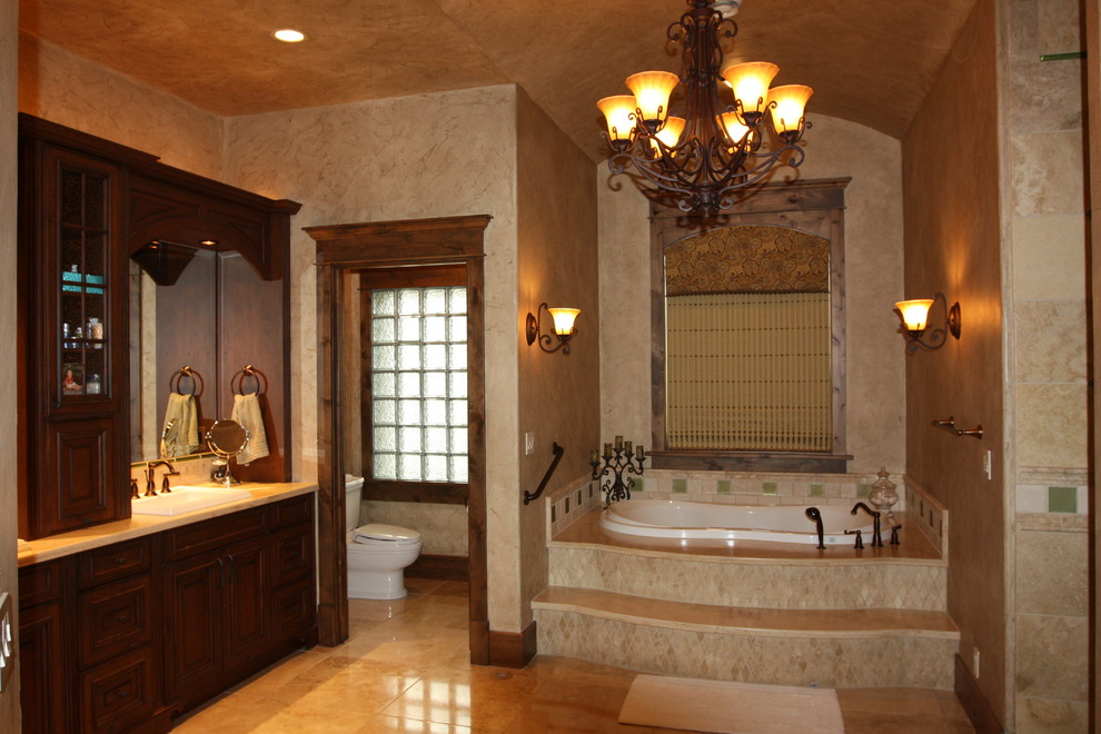 Example of a large mountain style master white tile ceramic tile bathroom design in Denver with a drop-in sink, dark wood cabinets, granite countertops, a two-piece toilet, blue walls and raised-panel cabinets