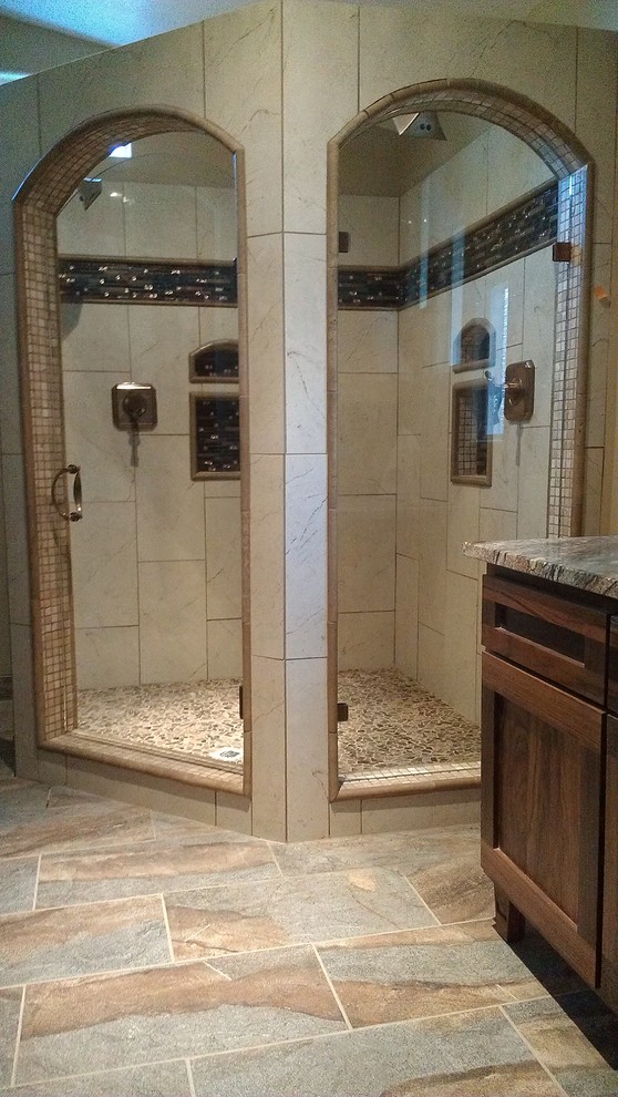 Corner shower - mid-sized southwestern master beige tile and ceramic tile ceramic tile and beige floor corner shower idea in Phoenix with shaker cabinets, dark wood cabinets, beige walls, an undermount sink, granite countertops and a hinged shower door