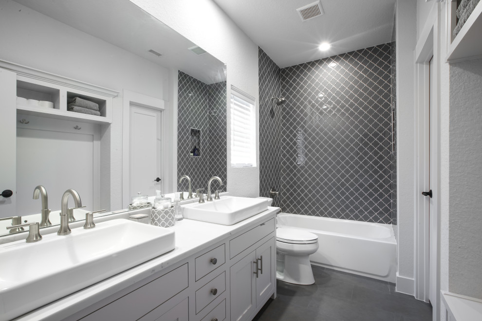 Inspiration for a mid-sized 1960s master gray tile and ceramic tile ceramic tile, gray floor and double-sink bathroom remodel in Dallas with recessed-panel cabinets, gray cabinets, a one-piece toilet, gray walls, a drop-in sink, granite countertops, gray countertops and a built-in vanity