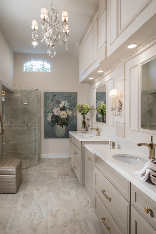 Mid-sized elegant master white tile and stone slab marble floor bathroom photo in St Louis with raised-panel cabinets, white cabinets, a one-piece toilet, beige walls, a drop-in sink, solid surface countertops and a hinged shower door