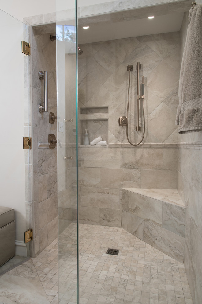Photo of a large classic ensuite bathroom in St Louis with raised-panel cabinets, grey cabinets, a built-in bath, a walk-in shower, a one-piece toilet, grey tiles, white tiles, stone slabs, white walls, marble flooring, a built-in sink, granite worktops, a wall niche and a shower bench.