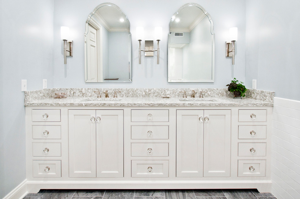 Mid-sized elegant master white tile and subway tile porcelain tile and gray floor bathroom photo in Nashville with flat-panel cabinets, white cabinets, blue walls, an undermount sink, quartz countertops, a hinged shower door and multicolored countertops