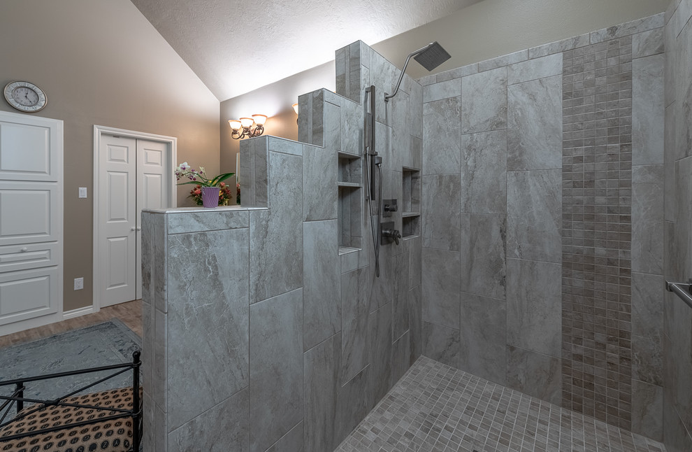Inspiration for a mid-sized contemporary master beige tile and ceramic tile painted wood floor and brown floor bathroom remodel in Austin with shaker cabinets, brown cabinets, beige walls, an undermount sink, marble countertops and multicolored countertops