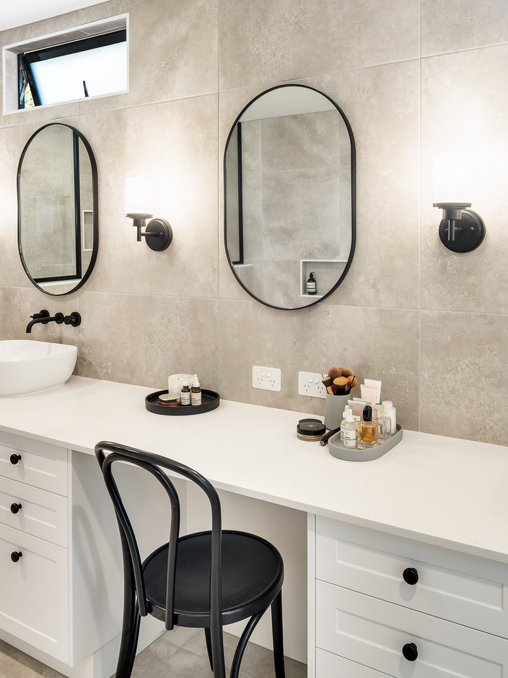 This is an example of a large contemporary ensuite bathroom in Brisbane with shaker cabinets, white cabinets, a built-in bath, a double shower, a one-piece toilet, beige tiles, porcelain tiles, beige walls, porcelain flooring, a console sink, solid surface worktops, beige floors, an open shower and beige worktops.