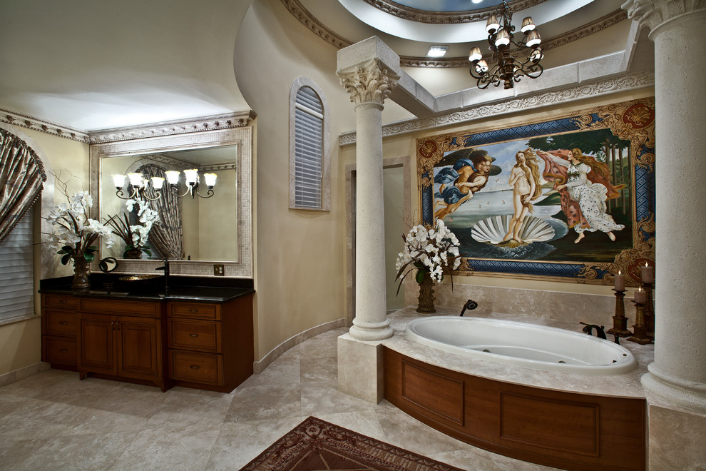 Example of a mid-sized tuscan master beige tile and stone tile marble floor bathroom design in Grand Rapids with a vessel sink, raised-panel cabinets, medium tone wood cabinets, granite countertops and beige walls