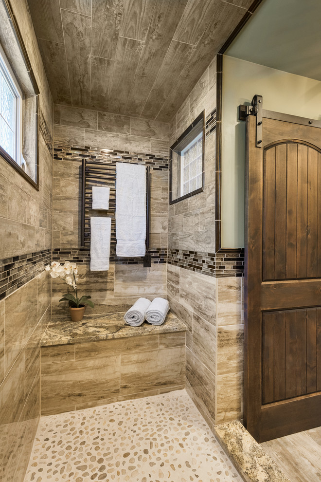 This is an example of a large rustic ensuite bathroom in Providence with raised-panel cabinets, dark wood cabinets, a walk-in shower, a two-piece toilet, beige tiles, porcelain tiles, a trough sink and granite worktops.