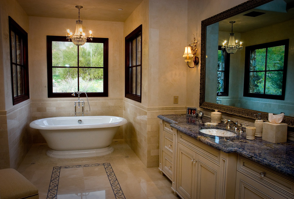 Example of a classic subway tile freestanding bathtub design in Phoenix with an undermount sink