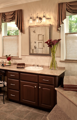 Mid-sized elegant master beige tile travertine floor bathroom photo in Other with a drop-in sink, raised-panel cabinets, dark wood cabinets, granite countertops, a one-piece toilet and beige walls