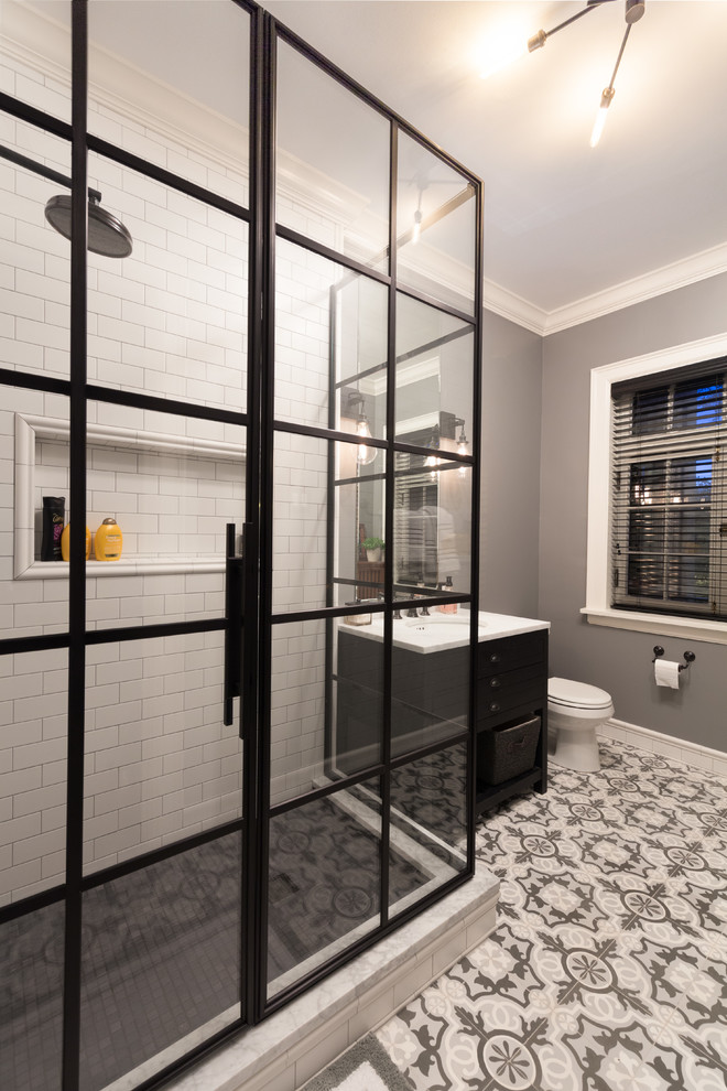 Mid-sized transitional master white tile and subway tile terra-cotta tile corner shower photo in Chicago with flat-panel cabinets, black cabinets, a two-piece toilet, gray walls, an undermount sink and marble countertops