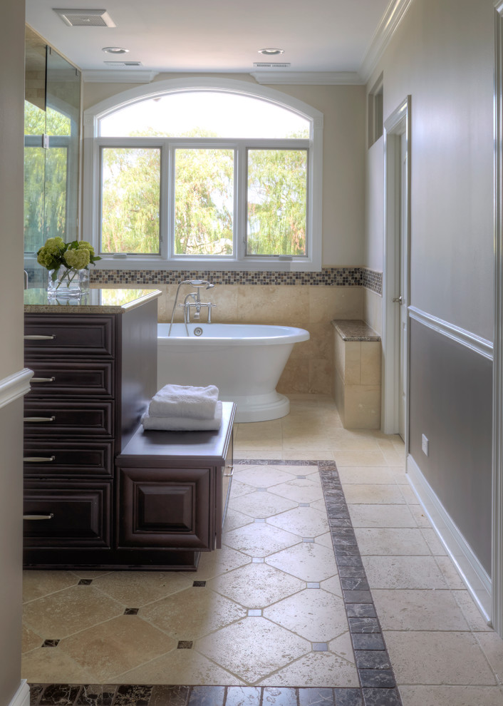 Bathroom - large traditional master beige tile and stone tile travertine floor bathroom idea in Chicago with an undermount sink, raised-panel cabinets, dark wood cabinets, marble countertops and beige walls