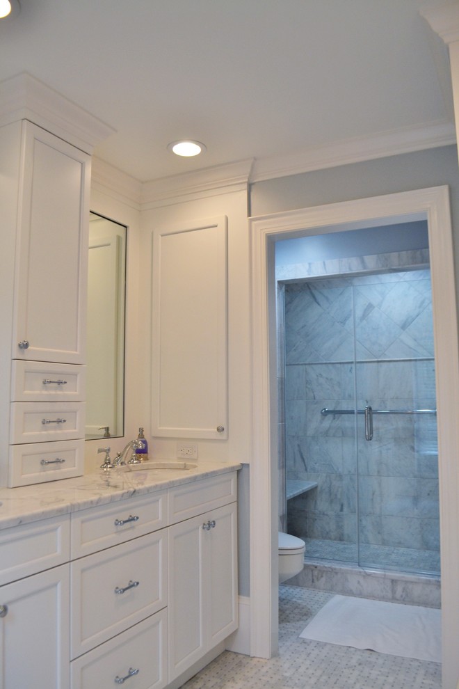 Elegant master bathroom photo in Raleigh with an undermount sink, white cabinets and marble countertops
