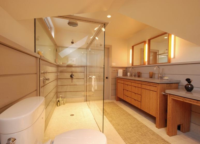 Inspiration pour une salle de bain principale design en bois brun de taille moyenne avec un placard à porte plane, une baignoire indépendante, un carrelage gris, des carreaux de béton, un sol en carrelage de porcelaine, un lavabo encastré et un plan de toilette en béton.