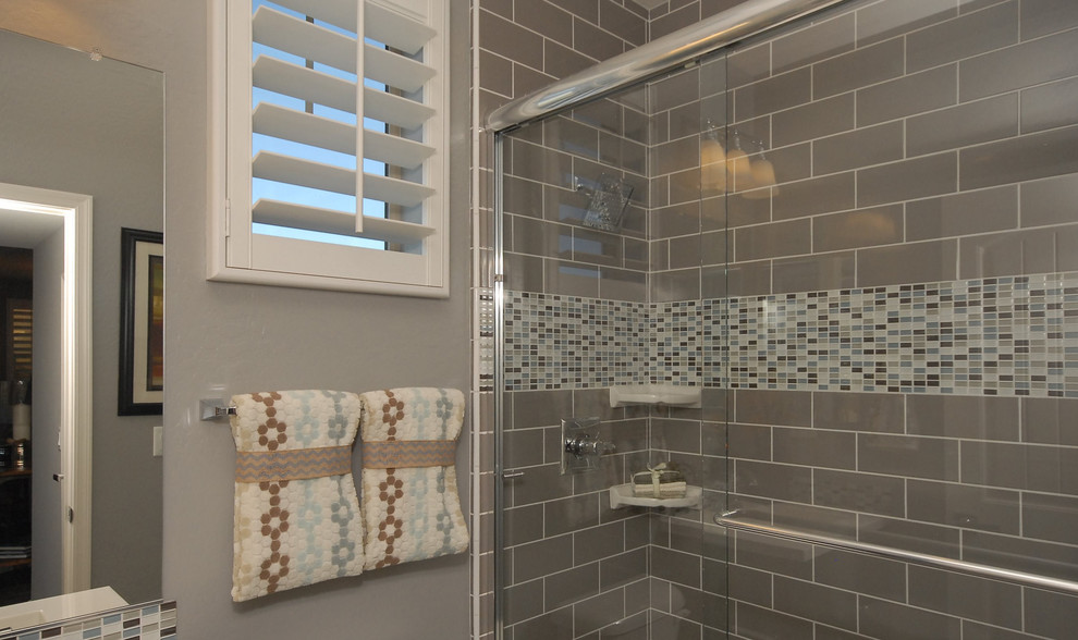 Medium sized traditional shower room bathroom in Phoenix with a built-in sink, flat-panel cabinets, dark wood cabinets, engineered stone worktops, a built-in shower, grey tiles, ceramic tiles, blue walls and ceramic flooring.
