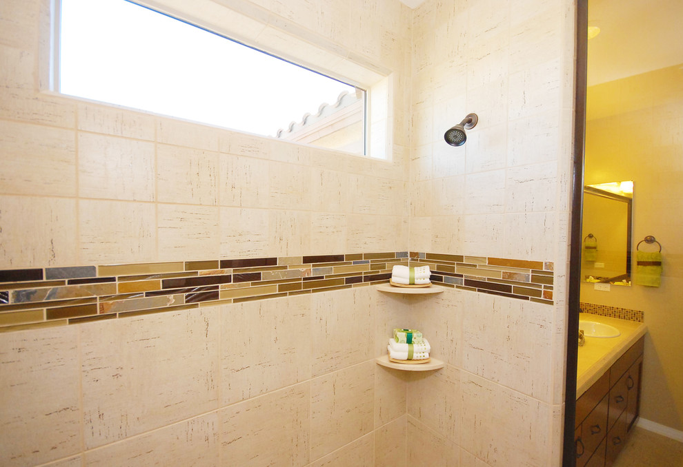 Medium sized contemporary ensuite bathroom in Phoenix with a built-in sink, flat-panel cabinets, medium wood cabinets, engineered stone worktops, a built-in shower, a one-piece toilet, white tiles, beige walls and ceramic flooring.