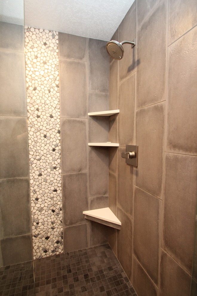This is an example of a large classic ensuite bathroom in Other with raised-panel cabinets, grey cabinets, a freestanding bath, a corner shower, a two-piece toilet, grey tiles, porcelain tiles, grey walls, porcelain flooring, a submerged sink, engineered stone worktops, grey floors and a hinged door.