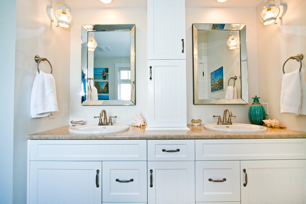 Example of a mid-sized classic 3/4 bathroom design in Vancouver with shaker cabinets, white cabinets, a drop-in sink, laminate countertops and beige countertops