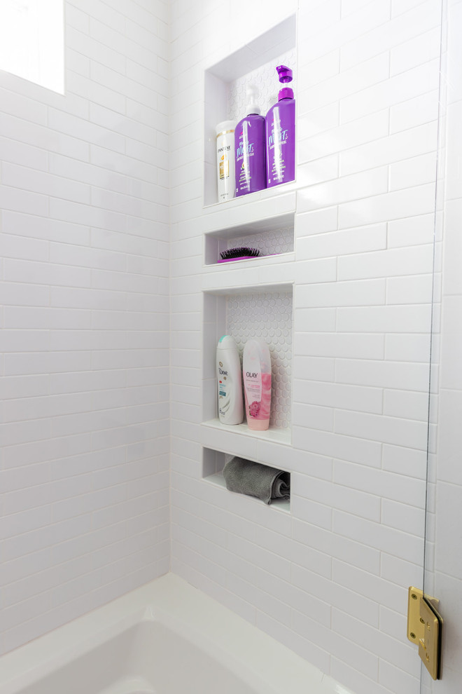 This is an example of a medium sized traditional family bathroom in Dallas with shaker cabinets, white cabinets, a built-in bath, a shower/bath combination, a two-piece toilet, white tiles, metro tiles, pink walls, porcelain flooring, a submerged sink, engineered stone worktops, grey floors, a hinged door, white worktops, a single sink, a built in vanity unit and wallpapered walls.