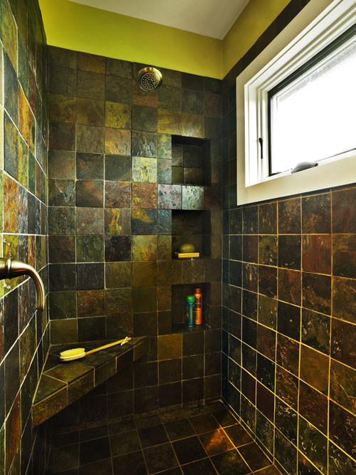 Doorless shower - large mediterranean master brown tile and ceramic tile ceramic tile doorless shower idea in Chicago with a pedestal sink, open cabinets, brown cabinets, tile countertops, a two-piece toilet and green walls