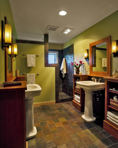 This is an example of a large mediterranean ensuite bathroom in Chicago with a pedestal sink, open cabinets, brown cabinets, a walk-in shower, a two-piece toilet, brown tiles, ceramic tiles, green walls and ceramic flooring.