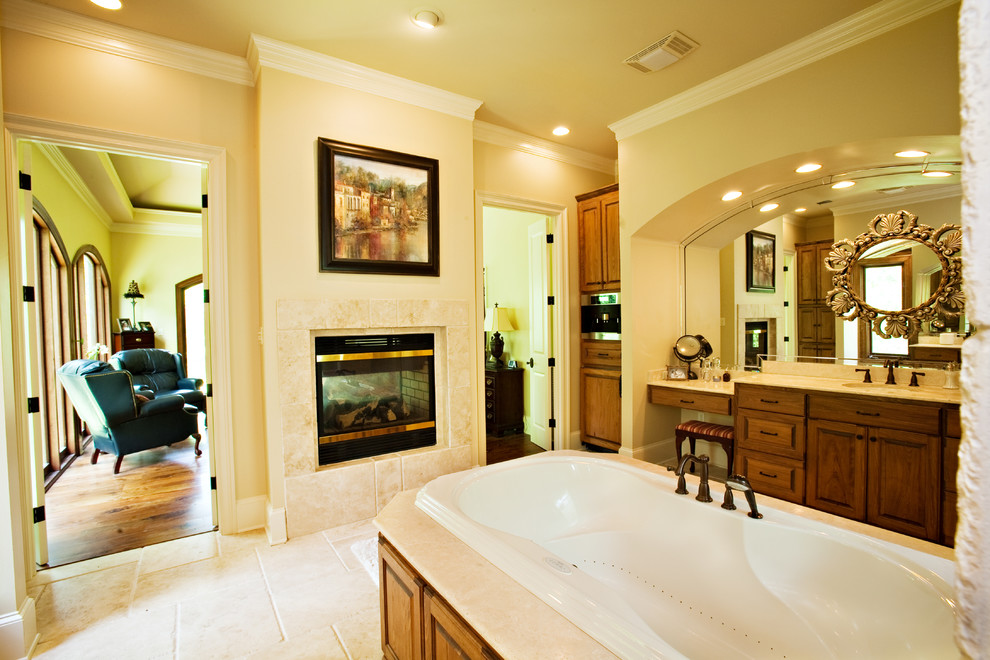 Design ideas for a large traditional ensuite bathroom in New Orleans with beaded cabinets, medium wood cabinets, a built-in bath, an alcove shower, beige tiles, stone tiles, beige walls, limestone flooring, a submerged sink and engineered stone worktops.