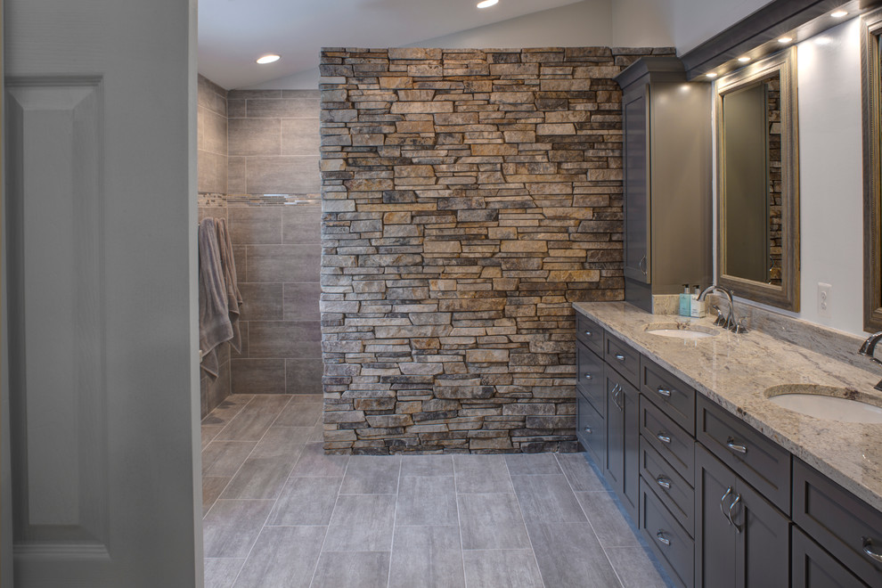 Walk-in shower - large modern master beige tile and stone tile porcelain tile walk-in shower idea in Baltimore with shaker cabinets, gray cabinets, white walls, an undermount sink and granite countertops