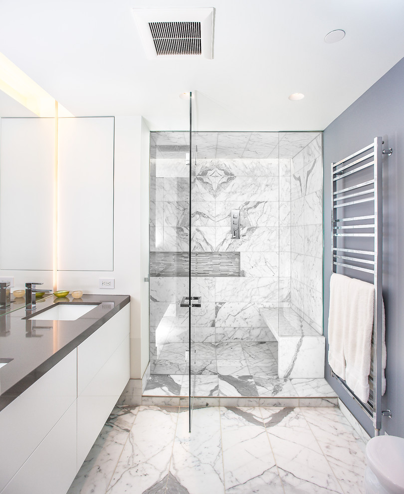 Design ideas for a large contemporary ensuite bathroom in Toronto with flat-panel cabinets, white cabinets, an alcove shower, white tiles, marble tiles, grey walls, marble flooring, a submerged sink, engineered stone worktops, grey floors and a hinged door.