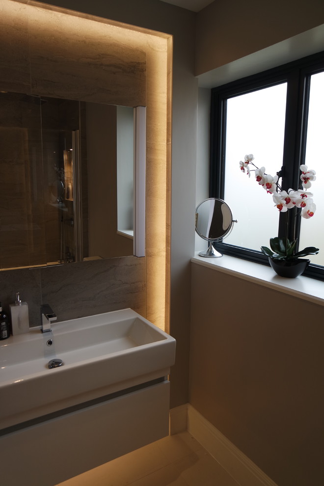 Photo of a medium sized modern family bathroom in Surrey with flat-panel cabinets, beige cabinets, grey tiles, porcelain tiles, porcelain flooring, an integrated sink, beige floors and white worktops.