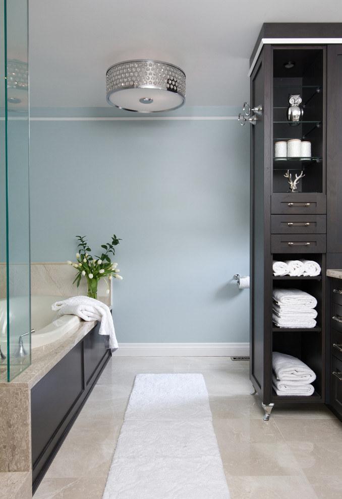 Inspiration for a mid-sized timeless multicolored tile and stone slab travertine floor bathroom remodel in Toronto with an undermount sink, a one-piece toilet, shaker cabinets, medium tone wood cabinets and blue walls