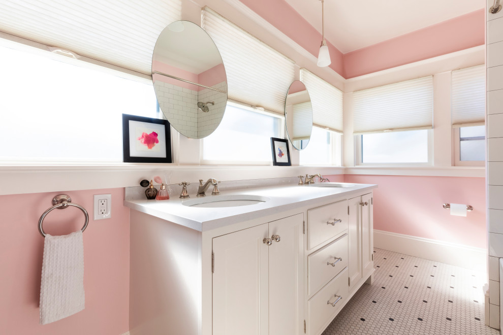 Photo of a traditional family bathroom in Portland with white cabinets, an alcove shower, pink walls, porcelain flooring, a submerged sink, engineered stone worktops, white floors and white worktops.