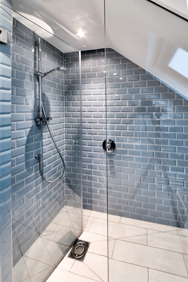 Small trendy master gray tile and ceramic tile light wood floor and beige floor doorless shower photo in London with flat-panel cabinets, white cabinets, a one-piece toilet, multicolored walls, a wall-mount sink and a hinged shower door