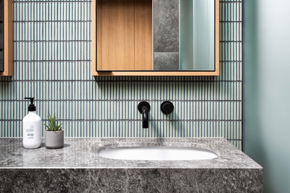 Mid-sized trendy master black and white tile, gray tile and ceramic tile ceramic tile and gray floor bathroom photo in Melbourne with flat-panel cabinets, white cabinets, a two-piece toilet, gray walls, a drop-in sink, quartz countertops, a hinged shower door and white countertops