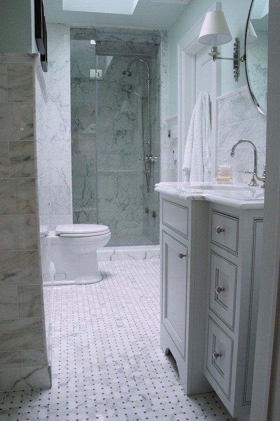 Foto på ett litet vintage en-suite badrum, med ett undermonterad handfat, luckor med infälld panel, vita skåp, en dusch i en alkov, en toalettstol med hel cisternkåpa, blå väggar, mosaikgolv, marmorbänkskiva, vit kakel och stenkakel