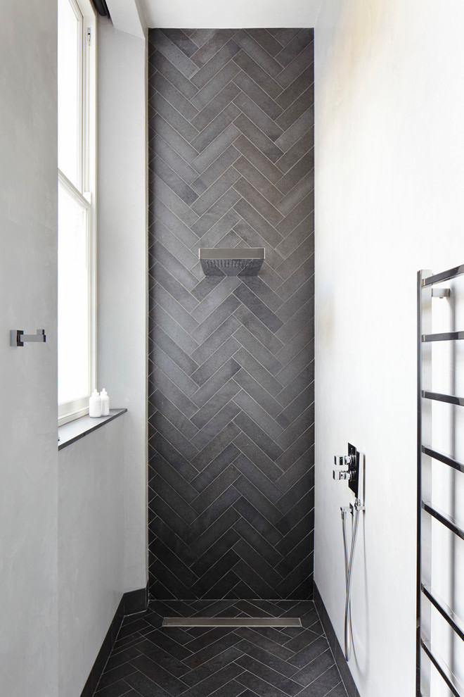 Example of a trendy gray tile bathroom design in London