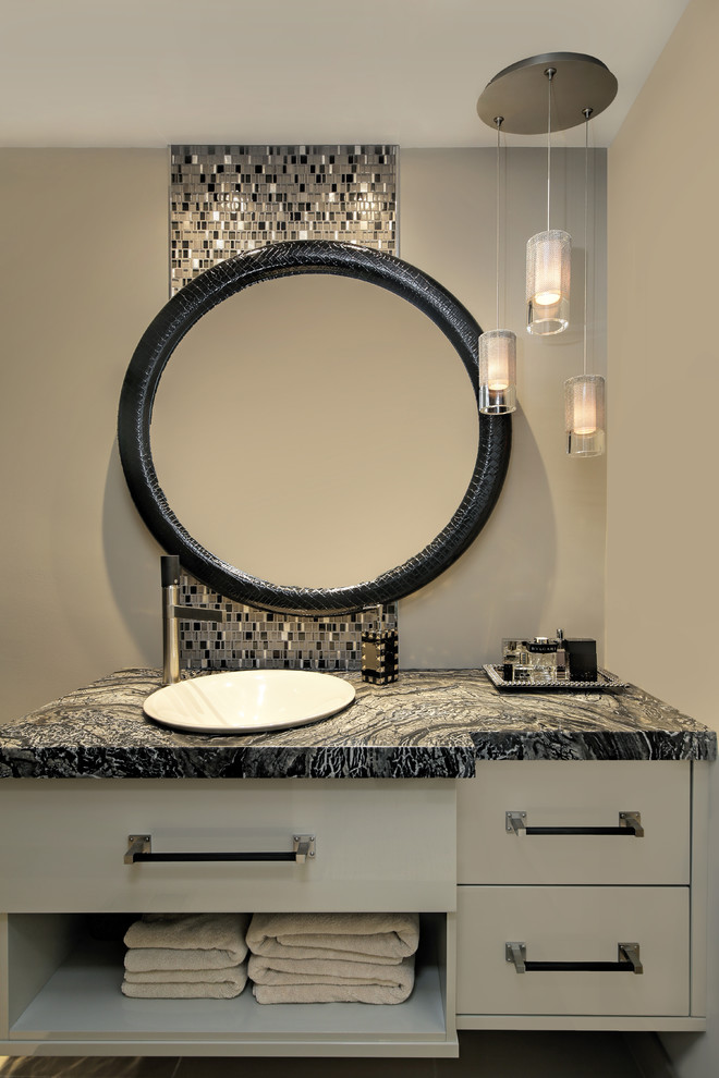 Modelo de cuarto de baño contemporáneo de tamaño medio con armarios con paneles lisos, puertas de armario beige, baldosas y/o azulejos negros, baldosas y/o azulejos en mosaico, lavabo encastrado, encimera de granito y encimeras negras