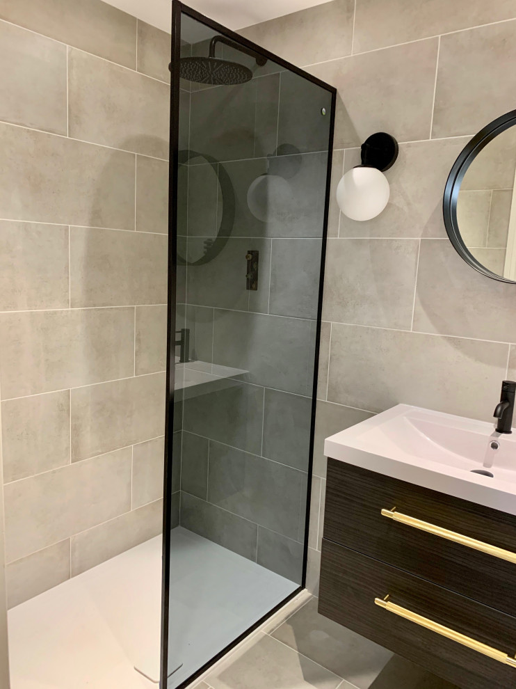 Photo of a small modern ensuite bathroom in Hertfordshire with flat-panel cabinets, black cabinets, porcelain tiles, porcelain flooring, an open shower, double sinks and a floating vanity unit.