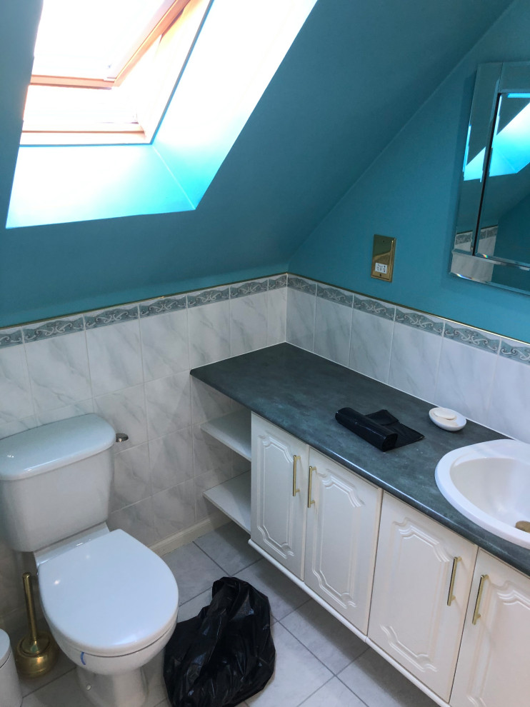 Modern wet room bathroom in Other with flat-panel cabinets, grey cabinets, a wall mounted toilet, grey tiles, porcelain tiles, grey walls, porcelain flooring, a built-in sink, engineered stone worktops, grey floors, an open shower, white worktops, a wall niche, double sinks and a floating vanity unit.