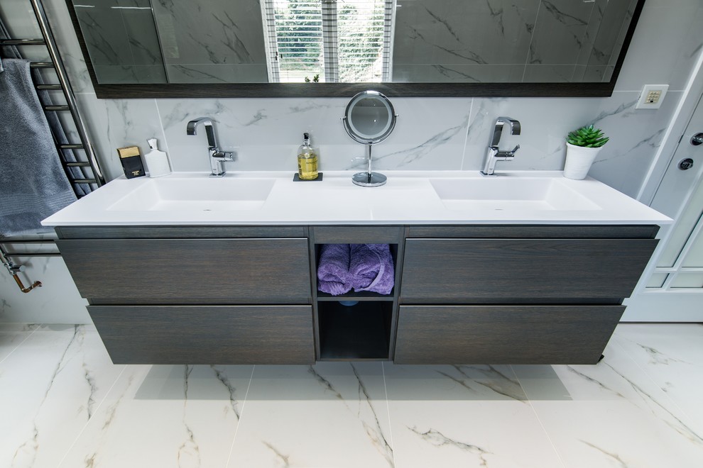 Photo of a large contemporary ensuite bathroom in Kent with dark wood cabinets, a built-in bath, a walk-in shower, white tiles, porcelain tiles, white walls, porcelain flooring, a wall-mounted sink, white floors and an open shower.