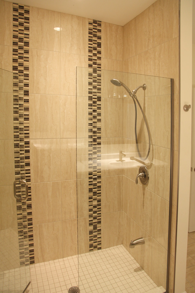 This is an example of a medium sized traditional ensuite bathroom in Toronto with dark wood cabinets, a walk-in shower, a one-piece toilet, beige tiles, brown tiles, porcelain tiles, an integrated sink, solid surface worktops, shaker cabinets, grey walls and porcelain flooring.